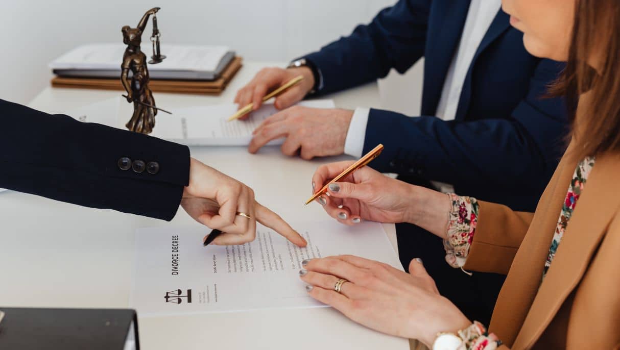 Spouse being directed to sign divorce papers by family lawyer